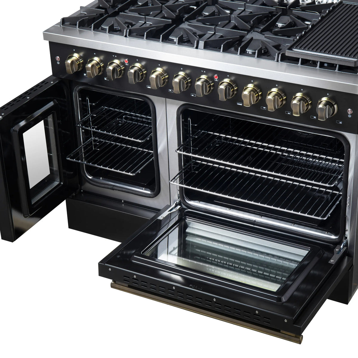 Black dual fuel range with open ovens, wire racks, and brass-trimmed controls over burners