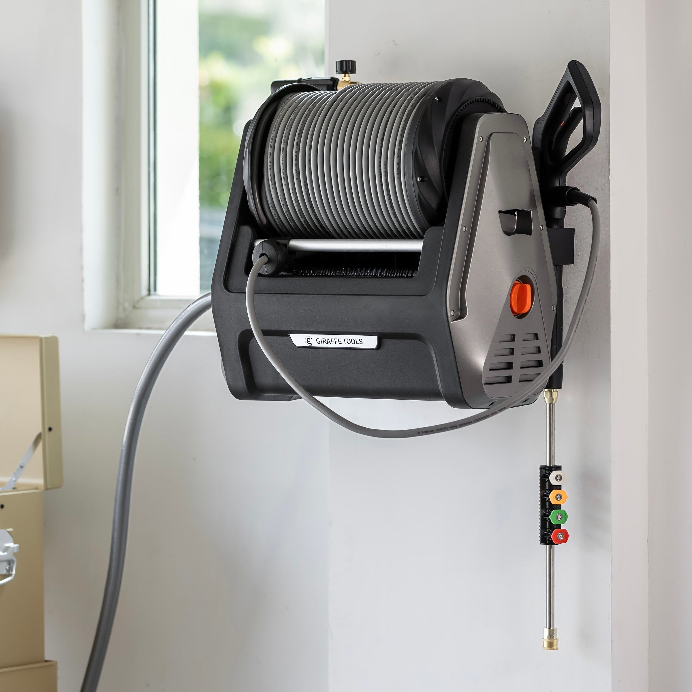 Retractable pressure washer unit with coiled hose reel and gray side handle
