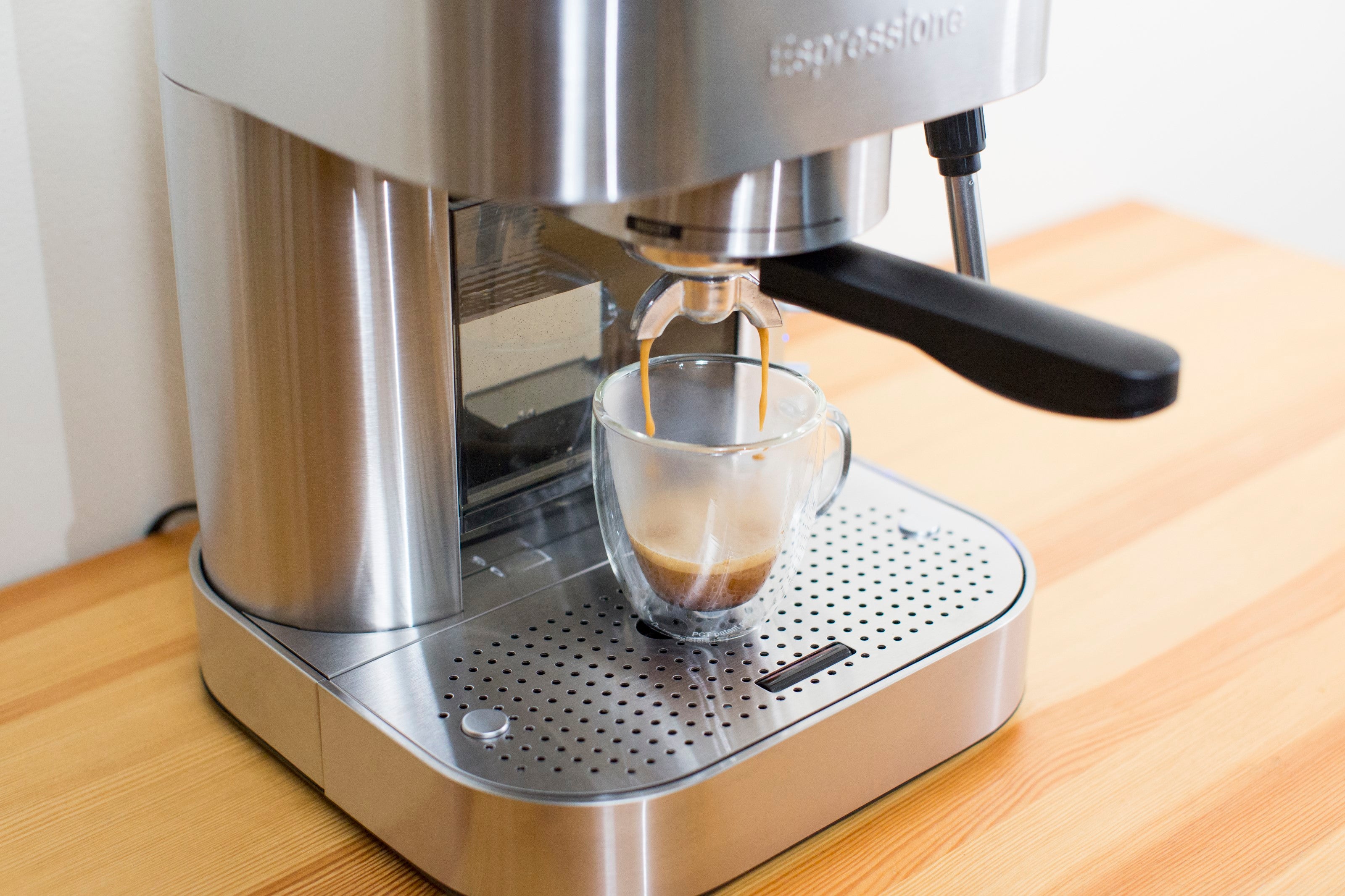 Espressione stainless steel espresso machine with glass cup on drip tray