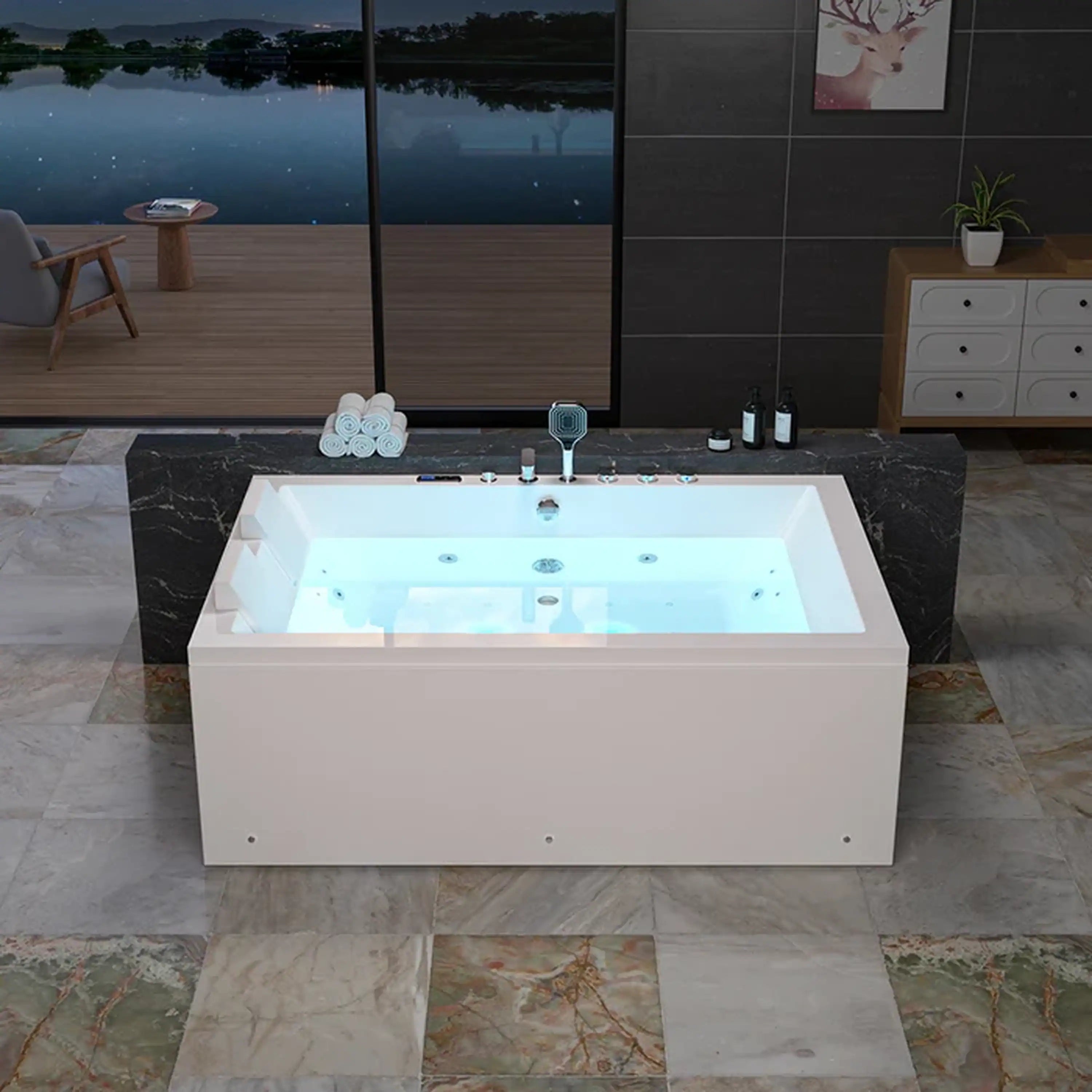 White alcove whirlpool bathtub with center drain and built-in rim controls