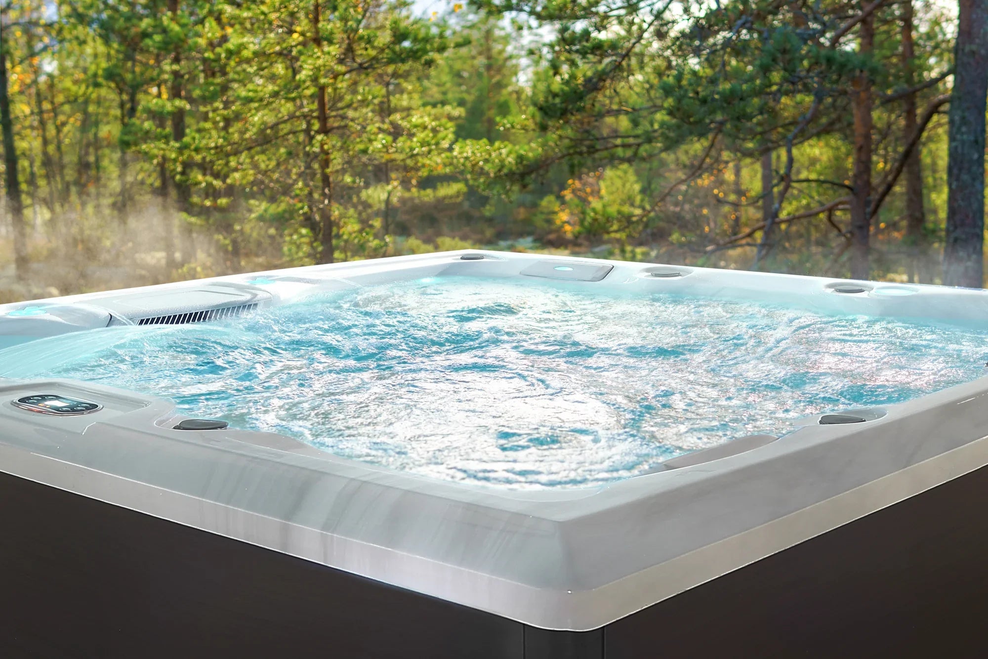 Gray freestanding outdoor hot tub with bubbling water and jets visible