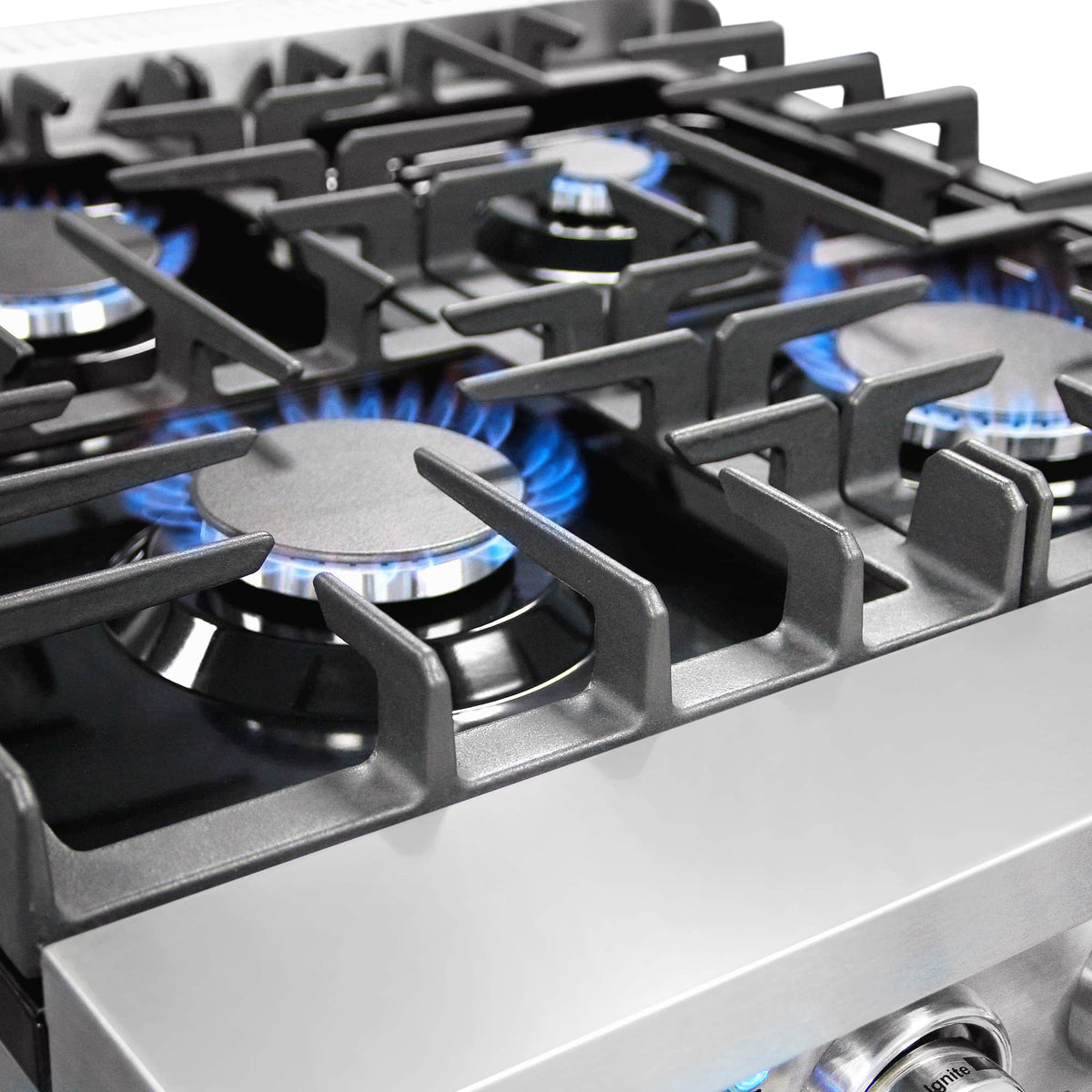 Stainless steel gas cooktop with four burners and blue flame
