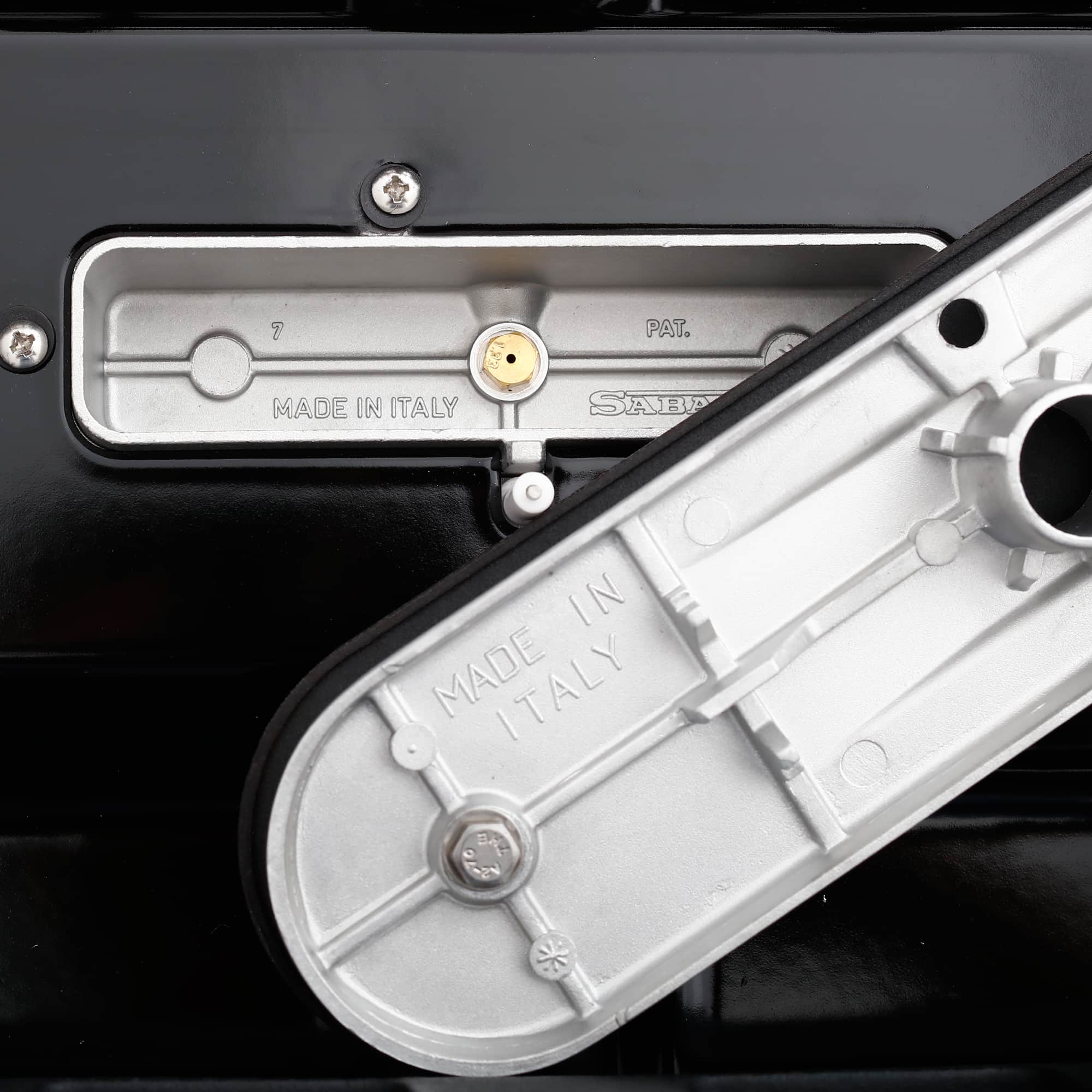 Stainless oven door hinge mechanism with stamped metal labels