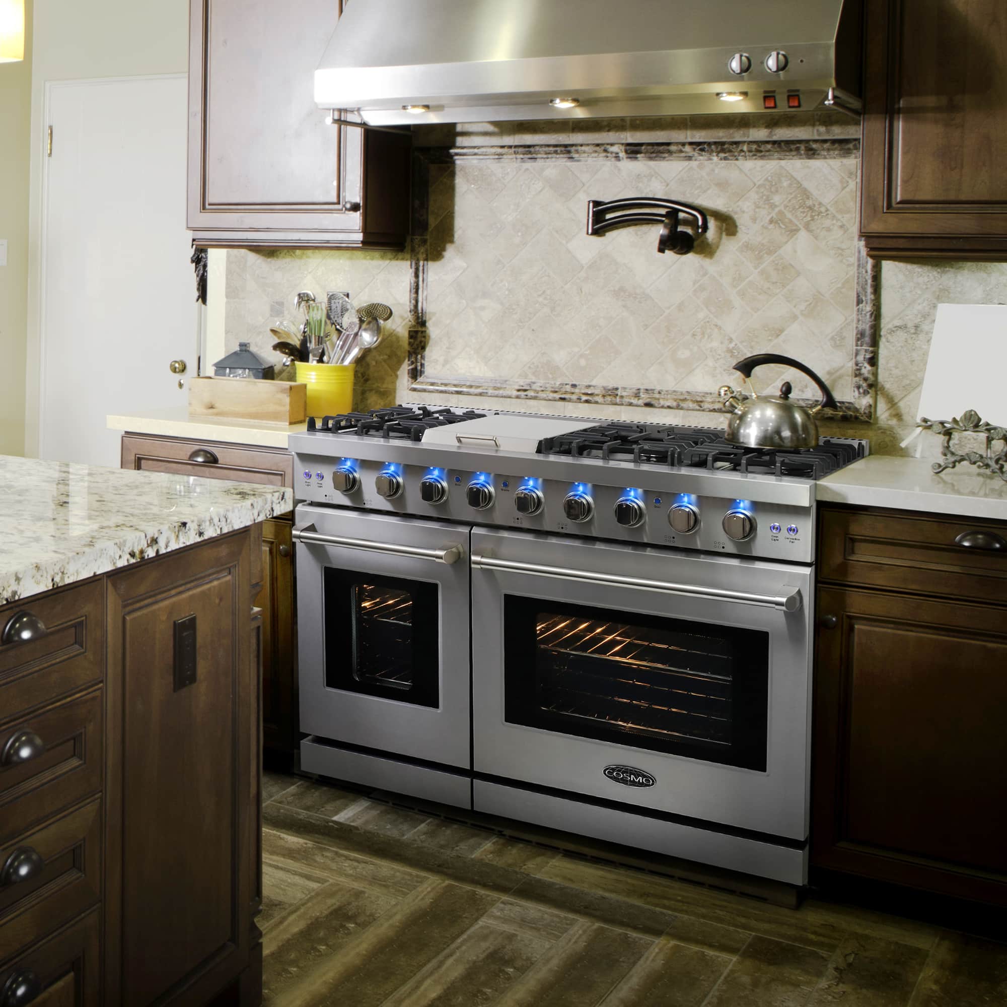 Stainless steel double oven gas range with two oven doors and lit cooktop burners