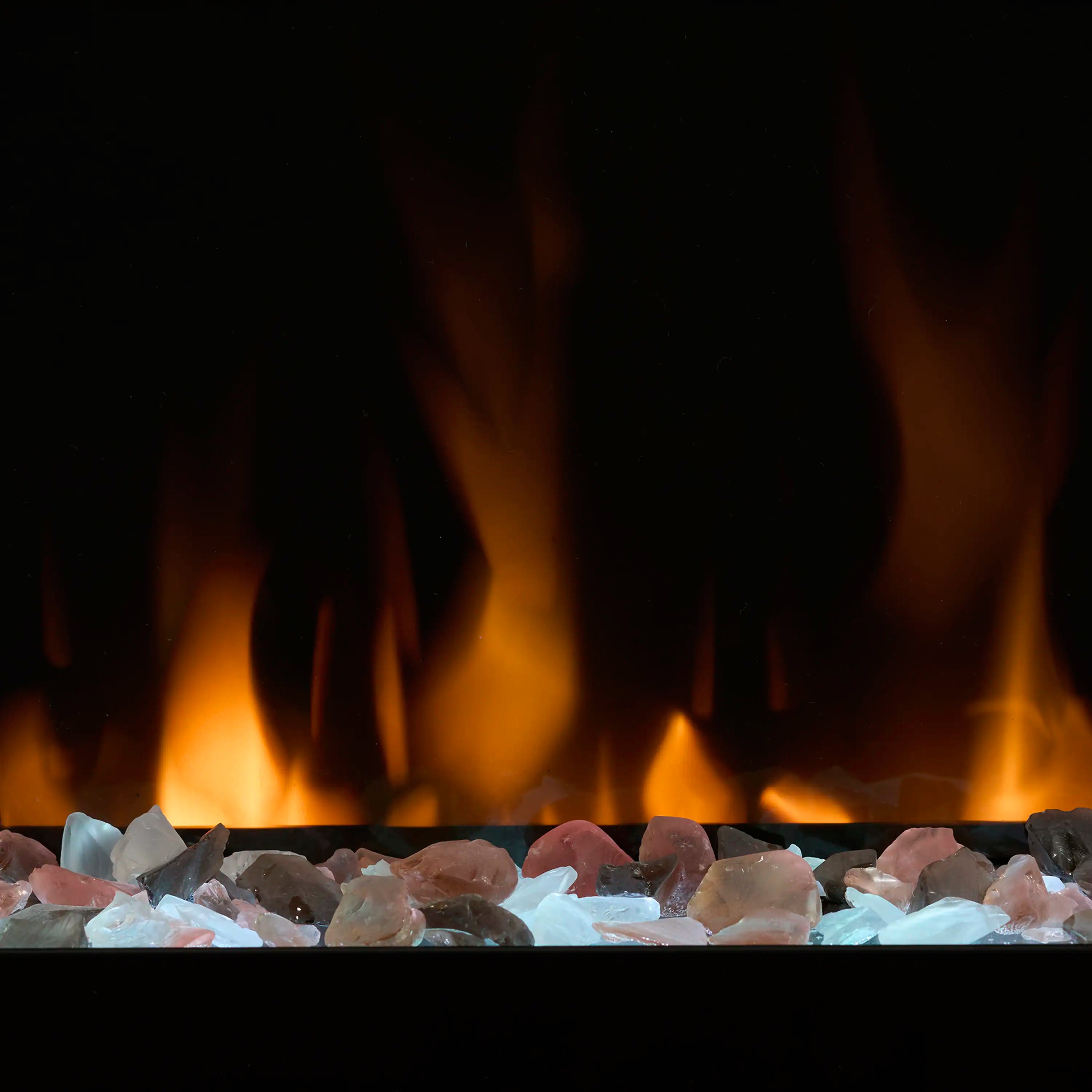 Electric fireplace ember bed with blue and clear rocks across the front and orange flames
