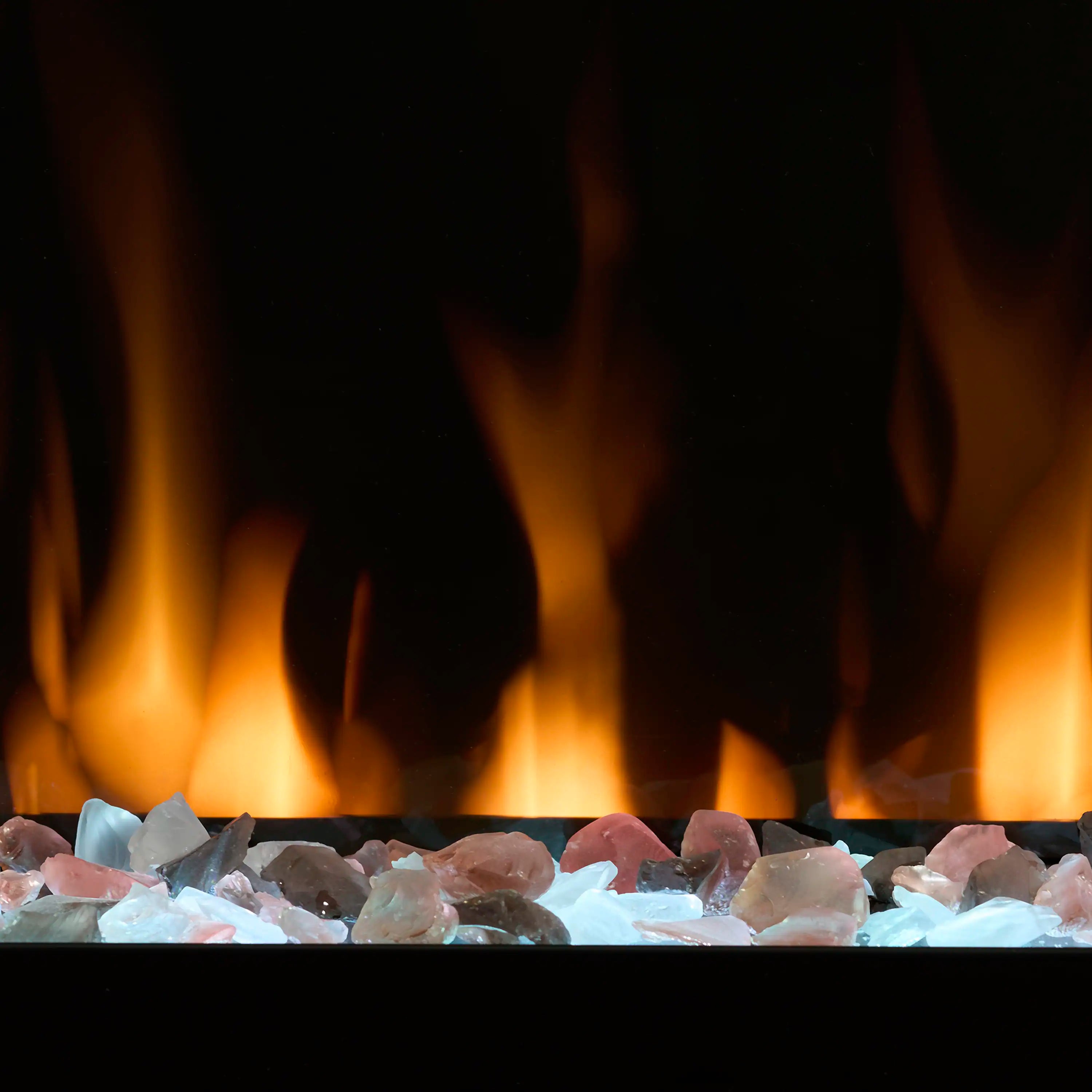 Electric fireplace ember bed showing blue and clear rocks with bright orange flame shapes