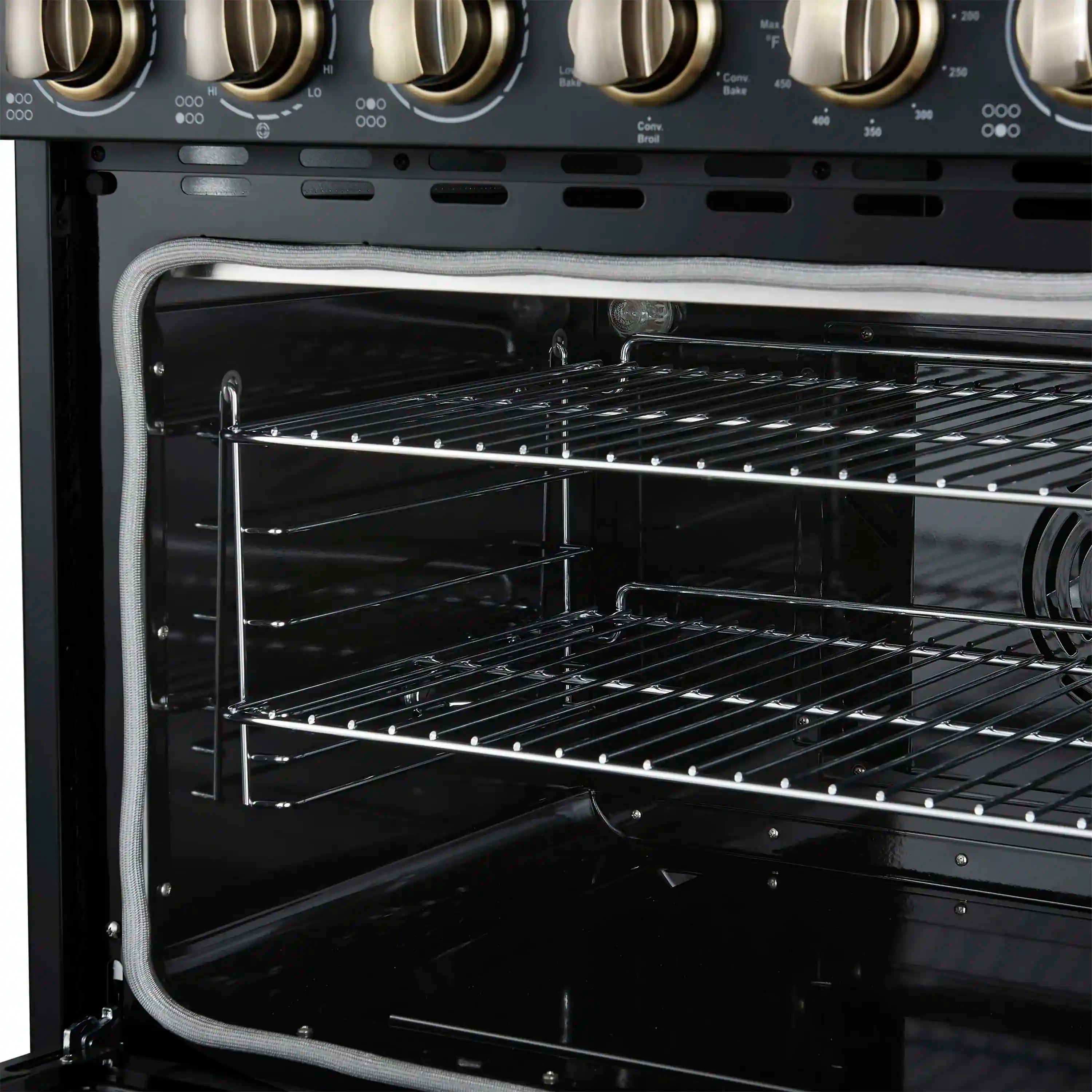 Black electric range oven cavity with two racks and open glass door