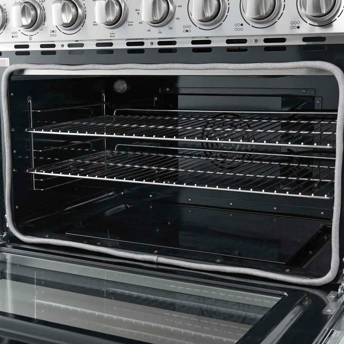 Electric oven interior with baking racks and side heating elements visible.