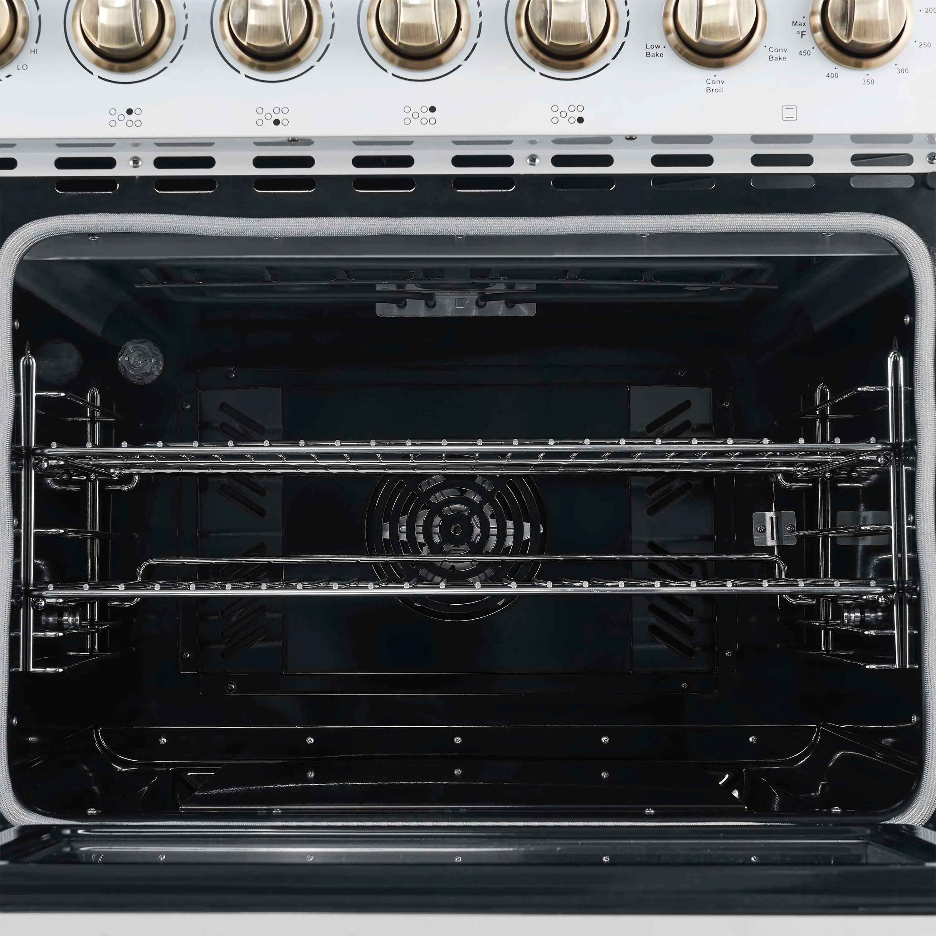 Electric oven cavity with racks and heating elements, viewed from open door