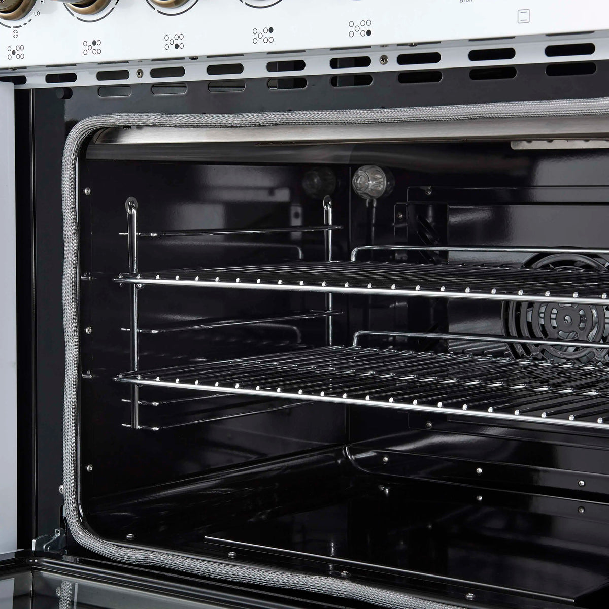 Convection oven interior with wire racks and heating elements, dark enamel finish