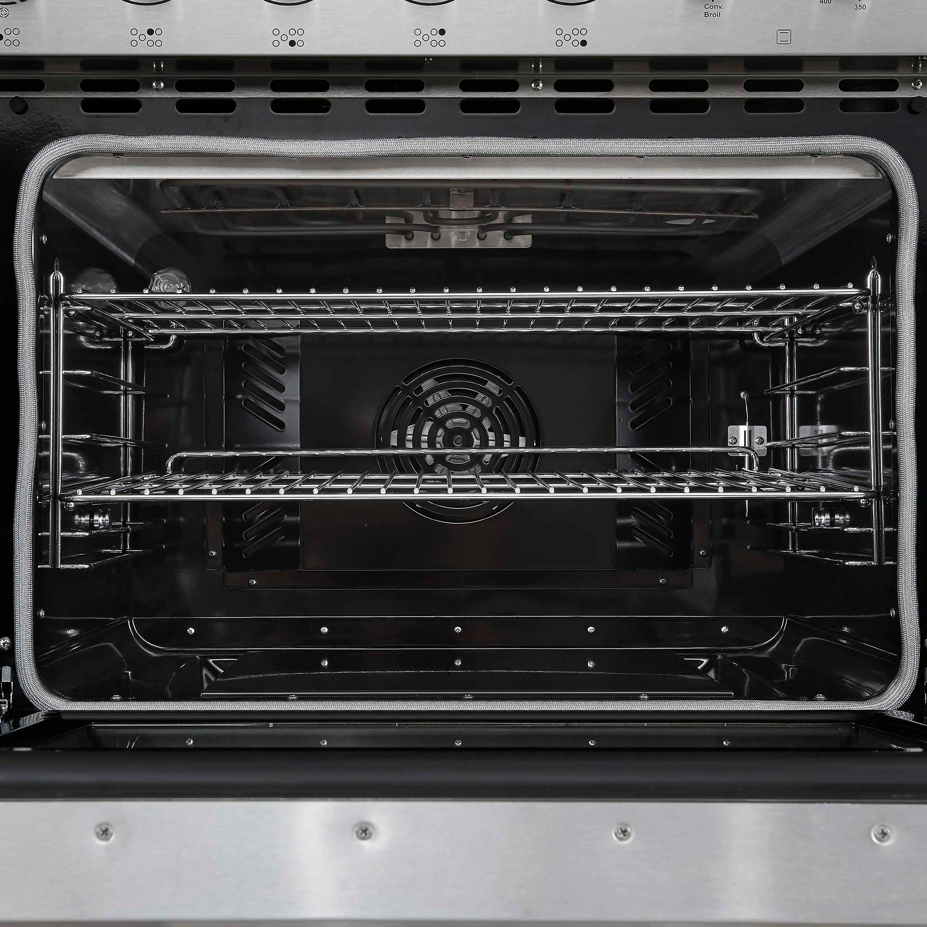 Electric oven interior with wire racks and central heating element, door open