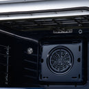 Electric oven door interior with convection fan outlet and oven racks inside