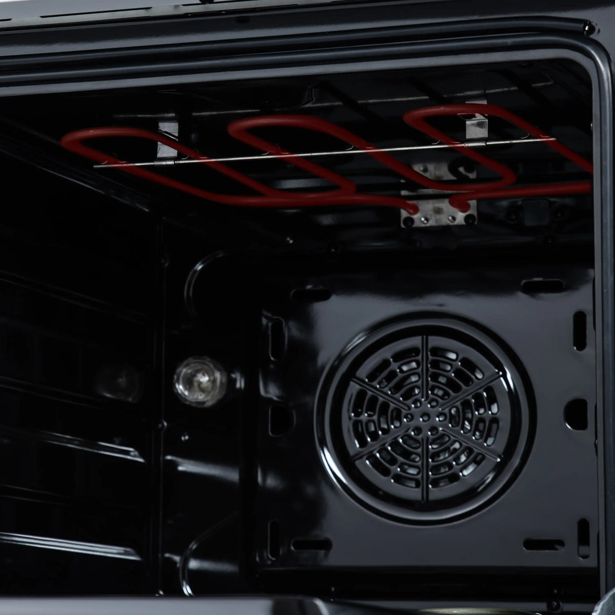 Freestanding electric range oven door with round convection fan and dark interior