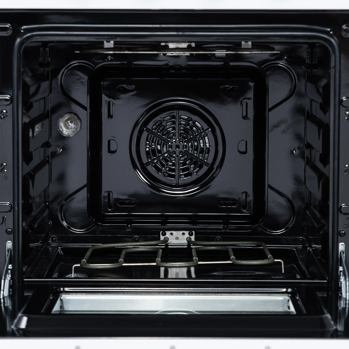 Electric oven cavity with black interior and circular fan vent at the back
