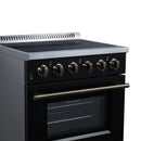 Black electric range with four radiant burners, brass control knobs, and lit oven window