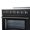 Freestanding electric range with brass control knobs and black oven door window