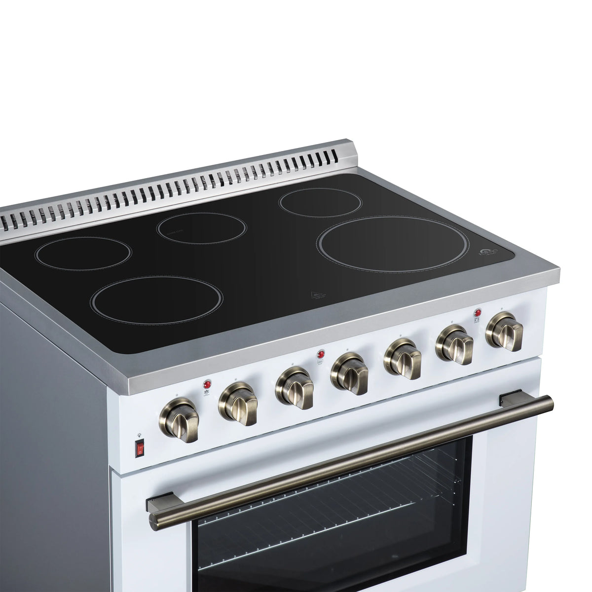 White electric range with black radiant cooktop and brass knobs above closed oven.