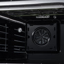 Convection oven interior with circular fan vent on the back wall and metal racks