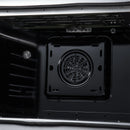 Electric oven cavity showing round convection fan and vent grille