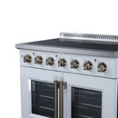 White electric range top controls with brass-finish knobs and two glass oven doors