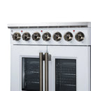 White electric range with twin oven doors, brass handles, and radiant cooktop knobs