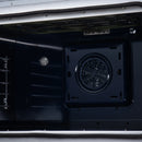 Electric oven interior fan vent with circular cover and metal racks