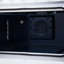 Electric range oven cavity with circular fan cover and dark interior walls