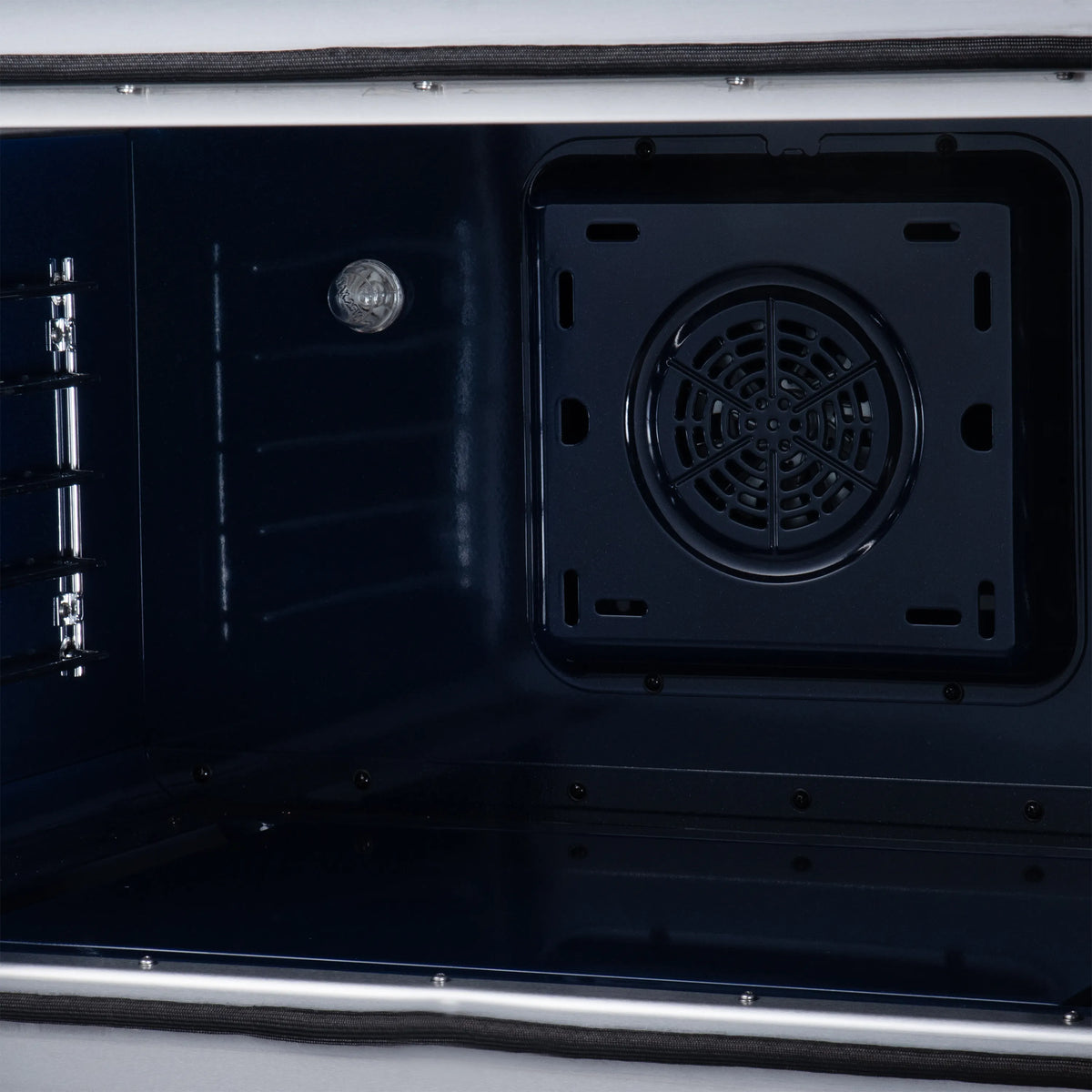Black electric range oven interior with round fan vent cover