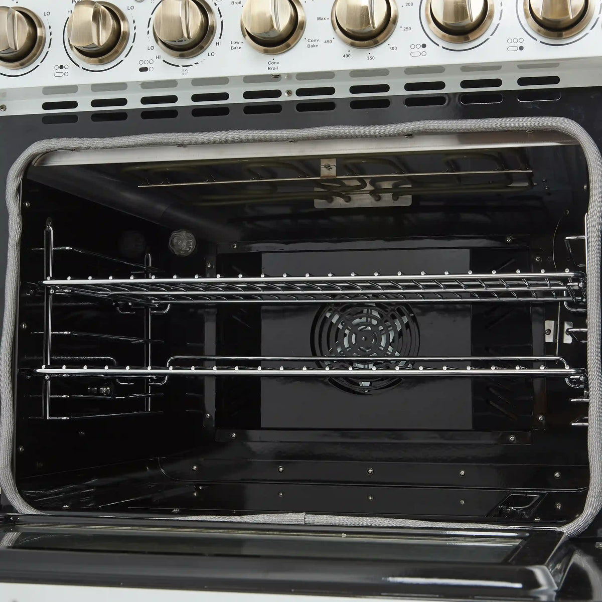 Open oven interior showing racks, fan vent, and back heating element