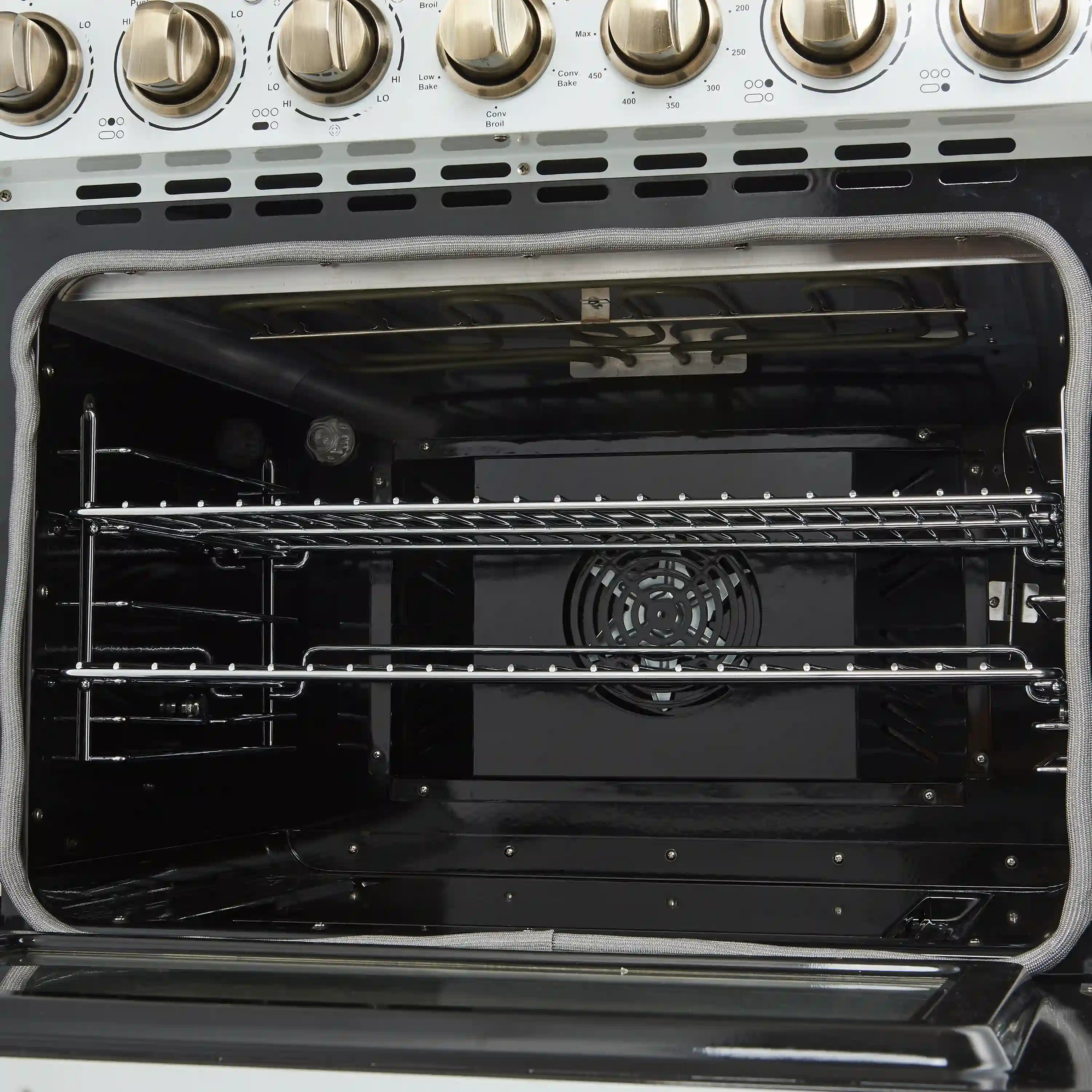 Electric range oven interior with racks and convection fan visible