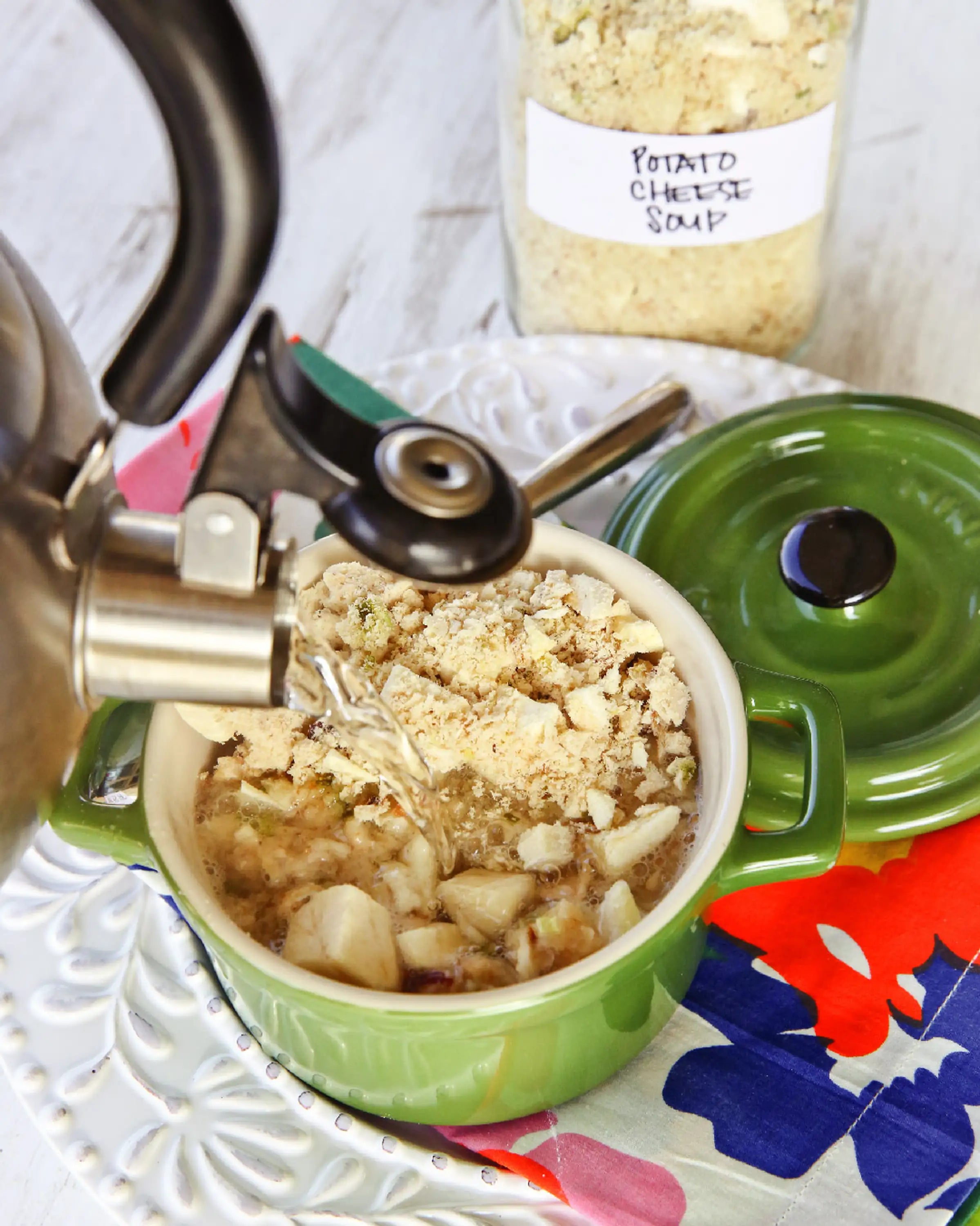 Rehydrating freeze-dried food in a green bowl with a metal pour spout