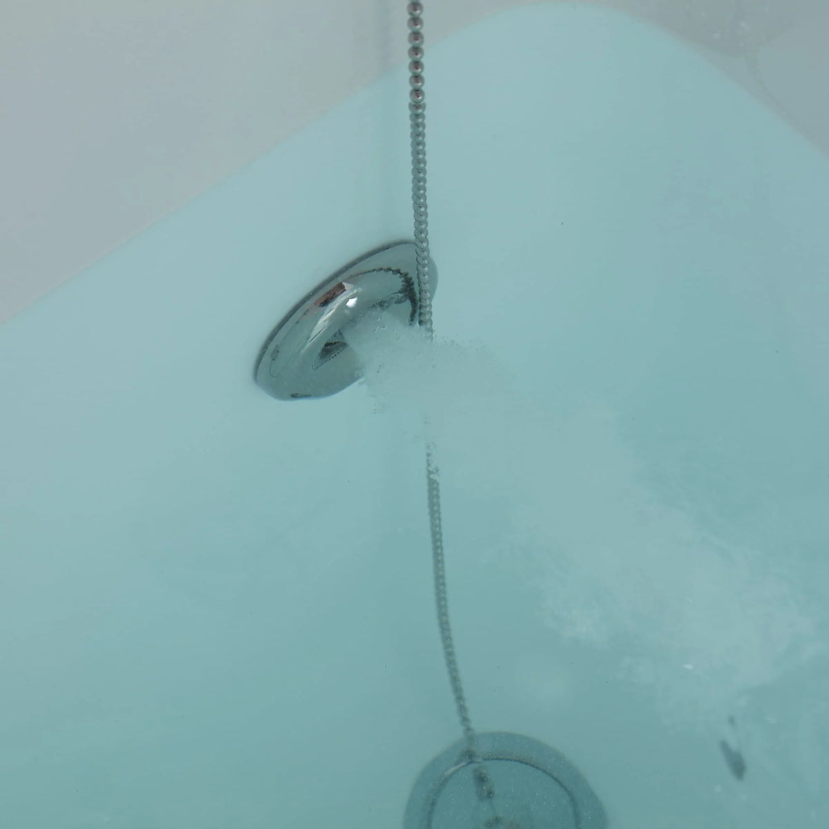 53-inch walk-in whirlpool bathtub close-up of shower hose spray in turquoise water