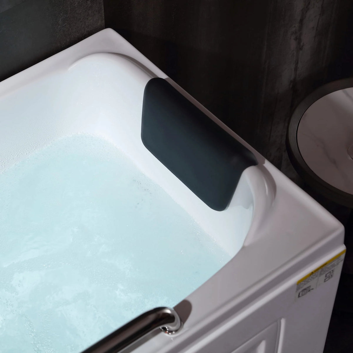 53-inch walk-in whirlpool bathtub close-up of dark padded headrest and turquoise water