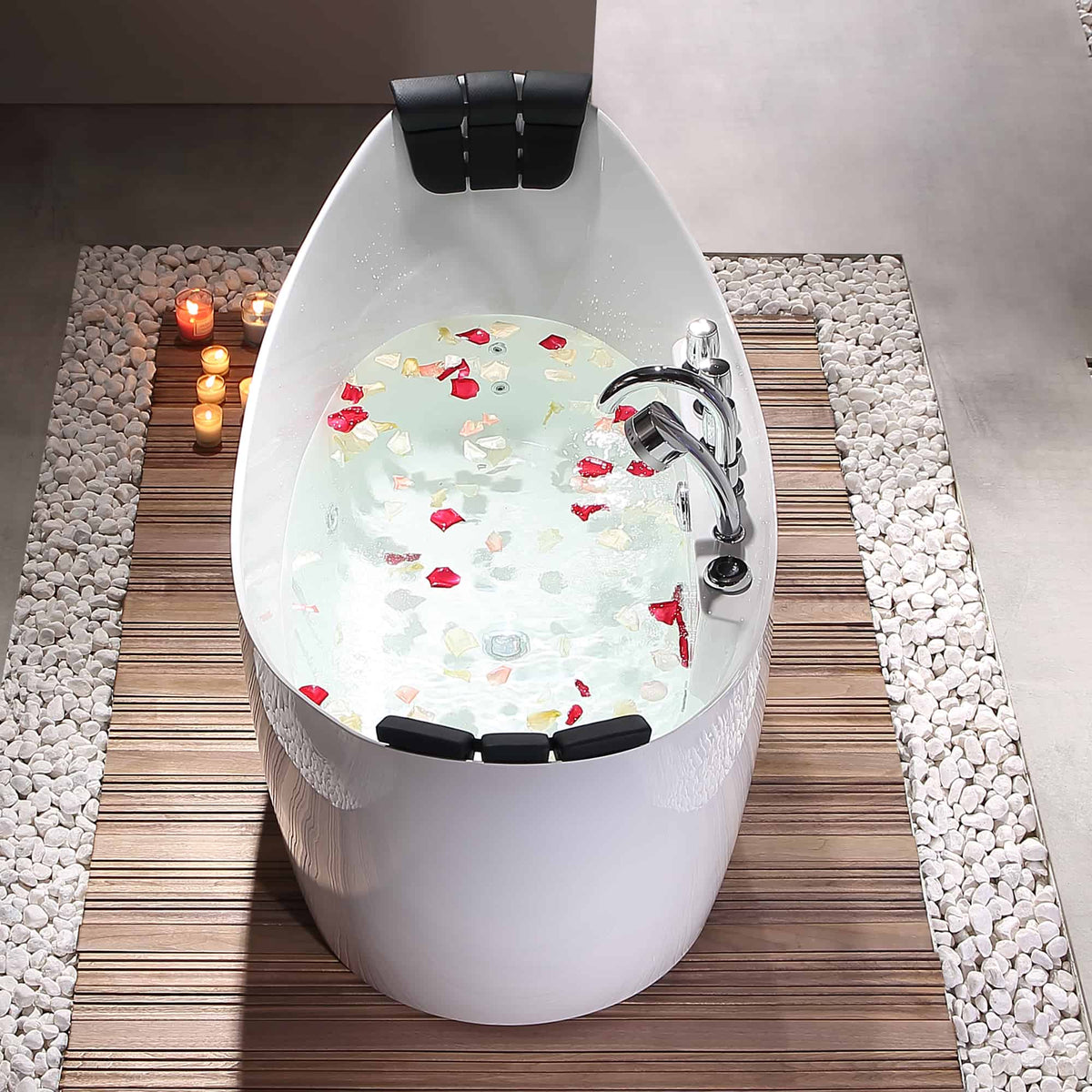 White freestanding acrylic whirlpool bathtub with chrome faucet and black headrests