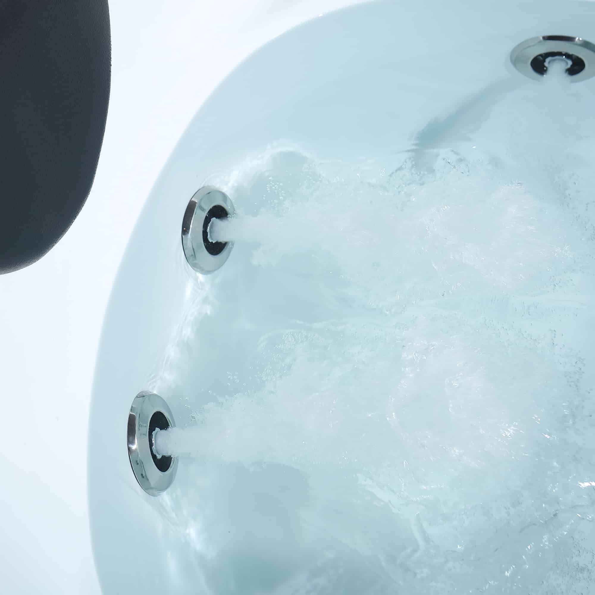 Close-up of whirlpool bathtub water jets on the inner wall with chrome fittings