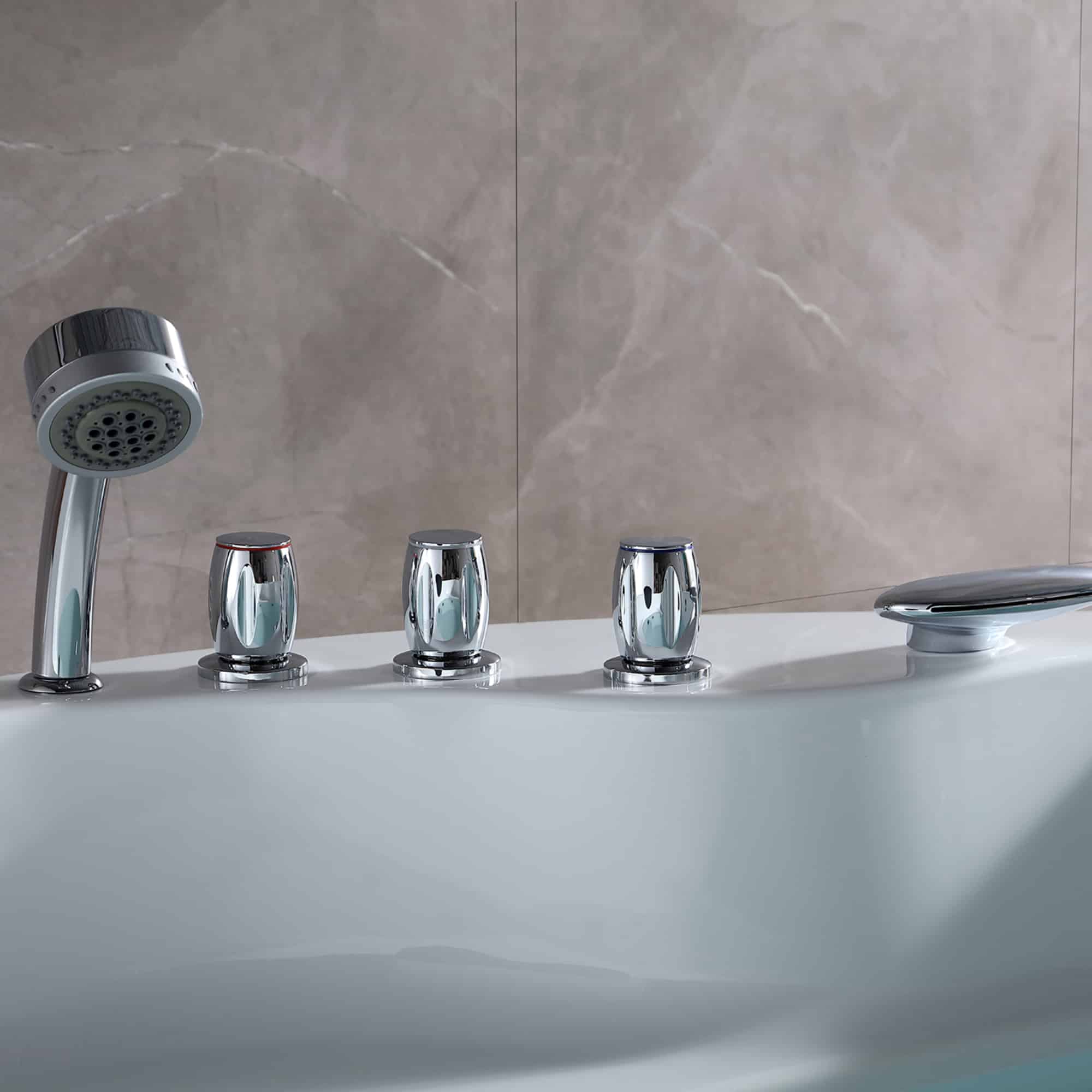 Close-up of chrome whirlpool bathtub faucet handles and showerhead on the rim