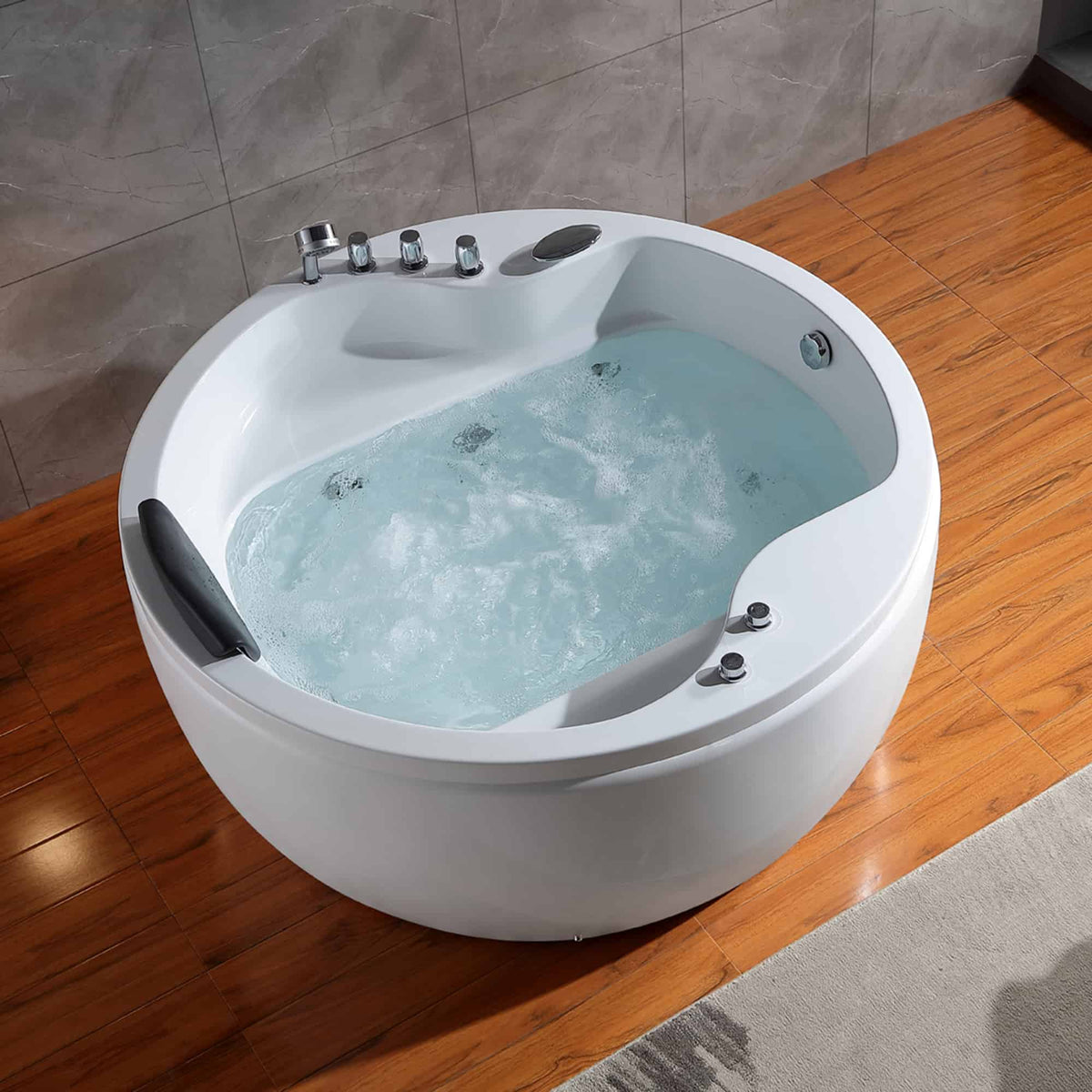 White round whirlpool bathtub with visible light blue whirlpool water and chrome jets