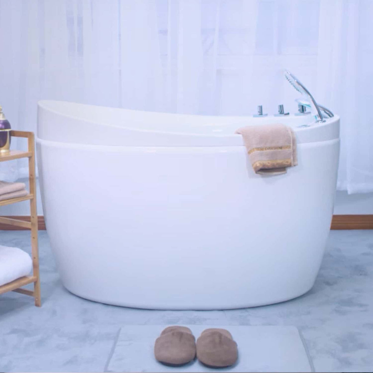 White freestanding air bathtub with chrome faucet, hand shower, and towel