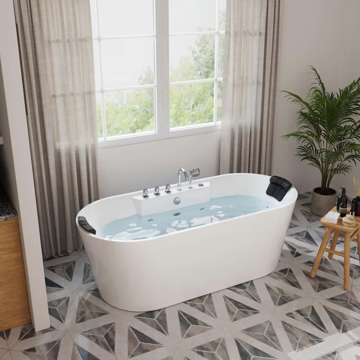 White freestanding acrylic whirlpool bathtub with blue water and black headrests.