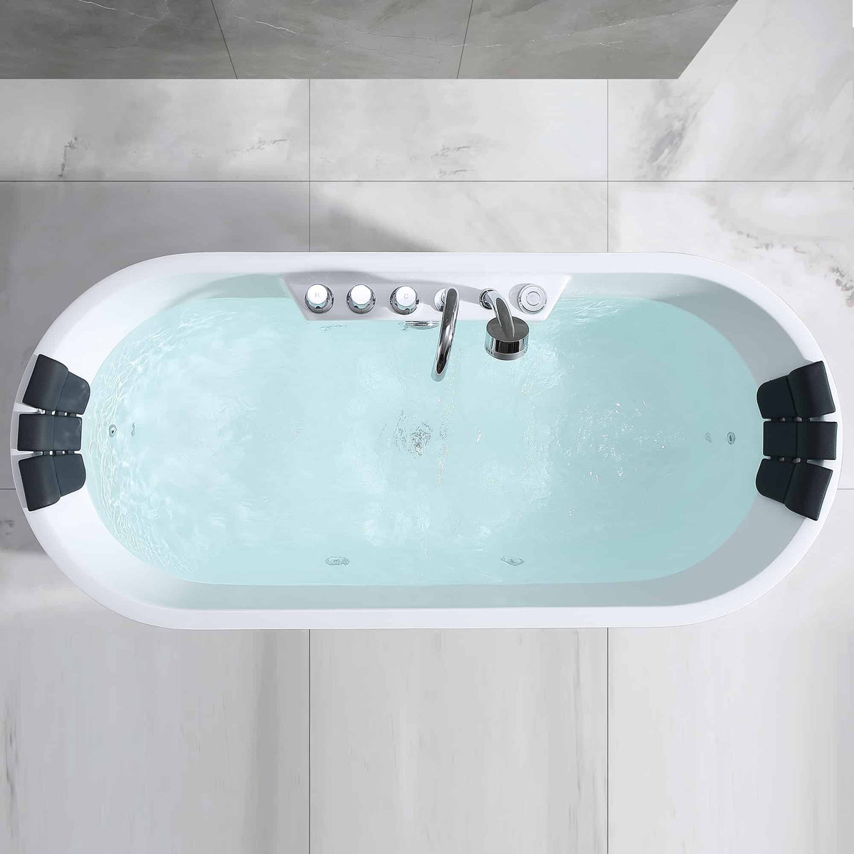 Top view of white freestanding acrylic whirlpool bathtub with blue water and jets.