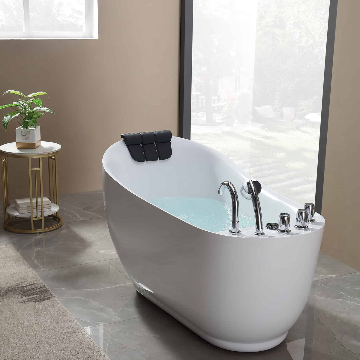 Freestanding acrylic bathtub with white finish and black headrest, chrome faucet set.