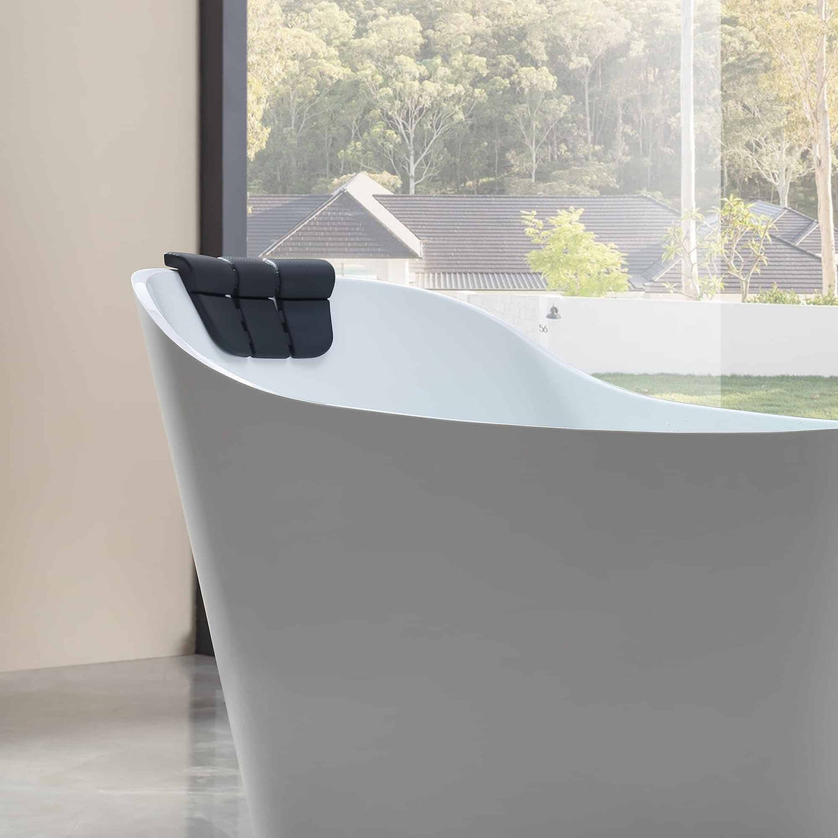 White freestanding acrylic whirlpool bathtub with dark headrest and curved side profile.