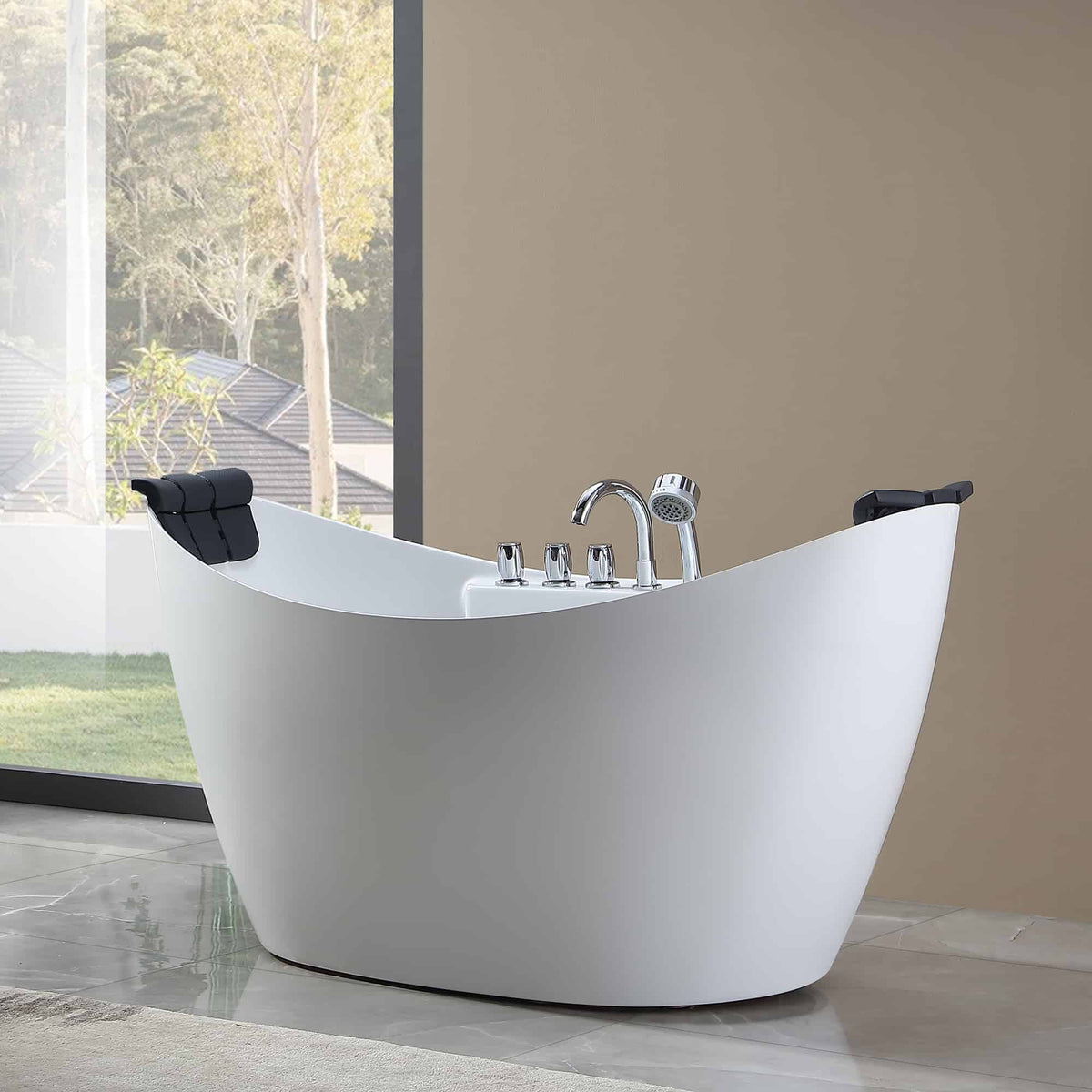 White freestanding acrylic soaking tub with chrome faucet and black headrests on rim.