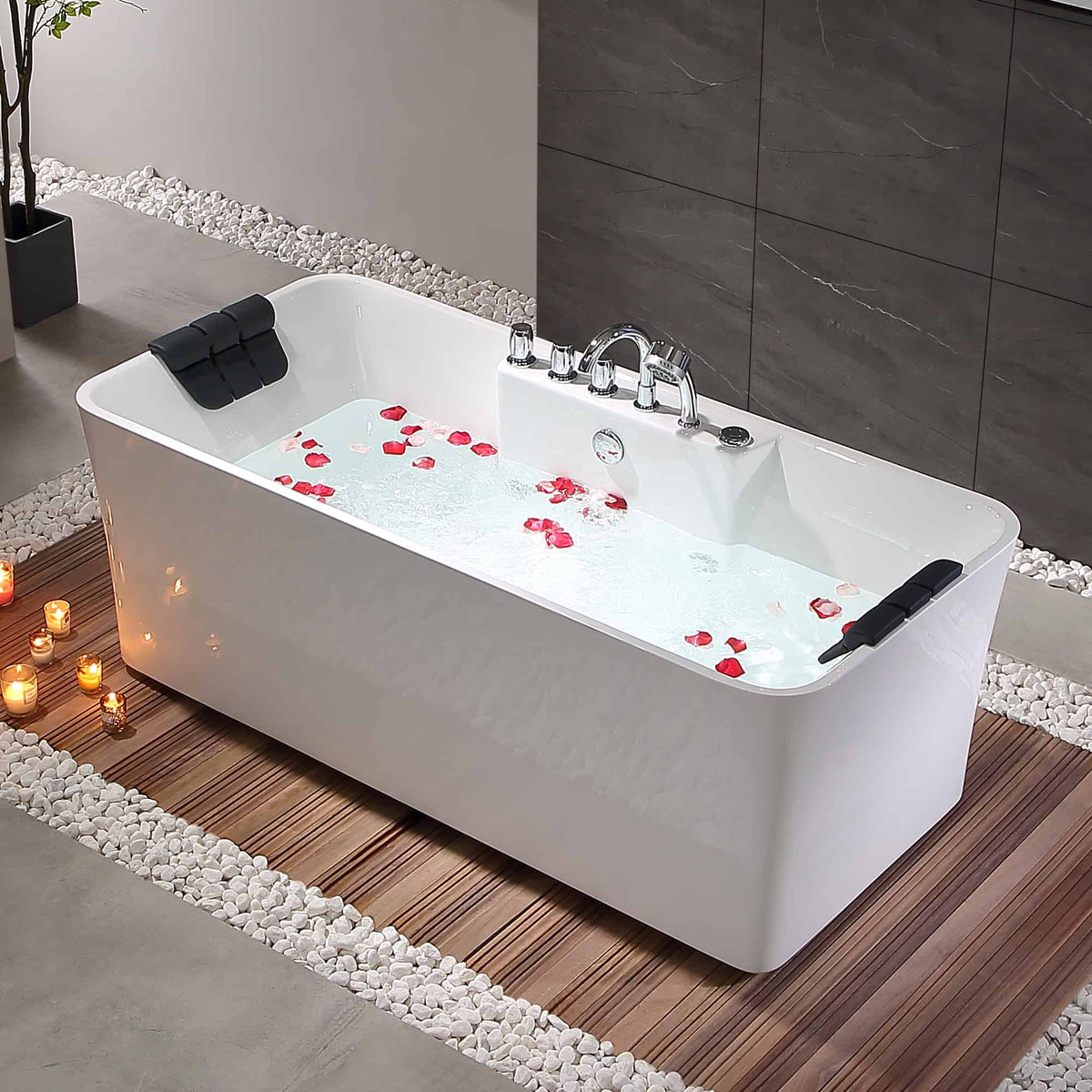 White acrylic whirlpool bathtub with water, rose petals, and black headrests