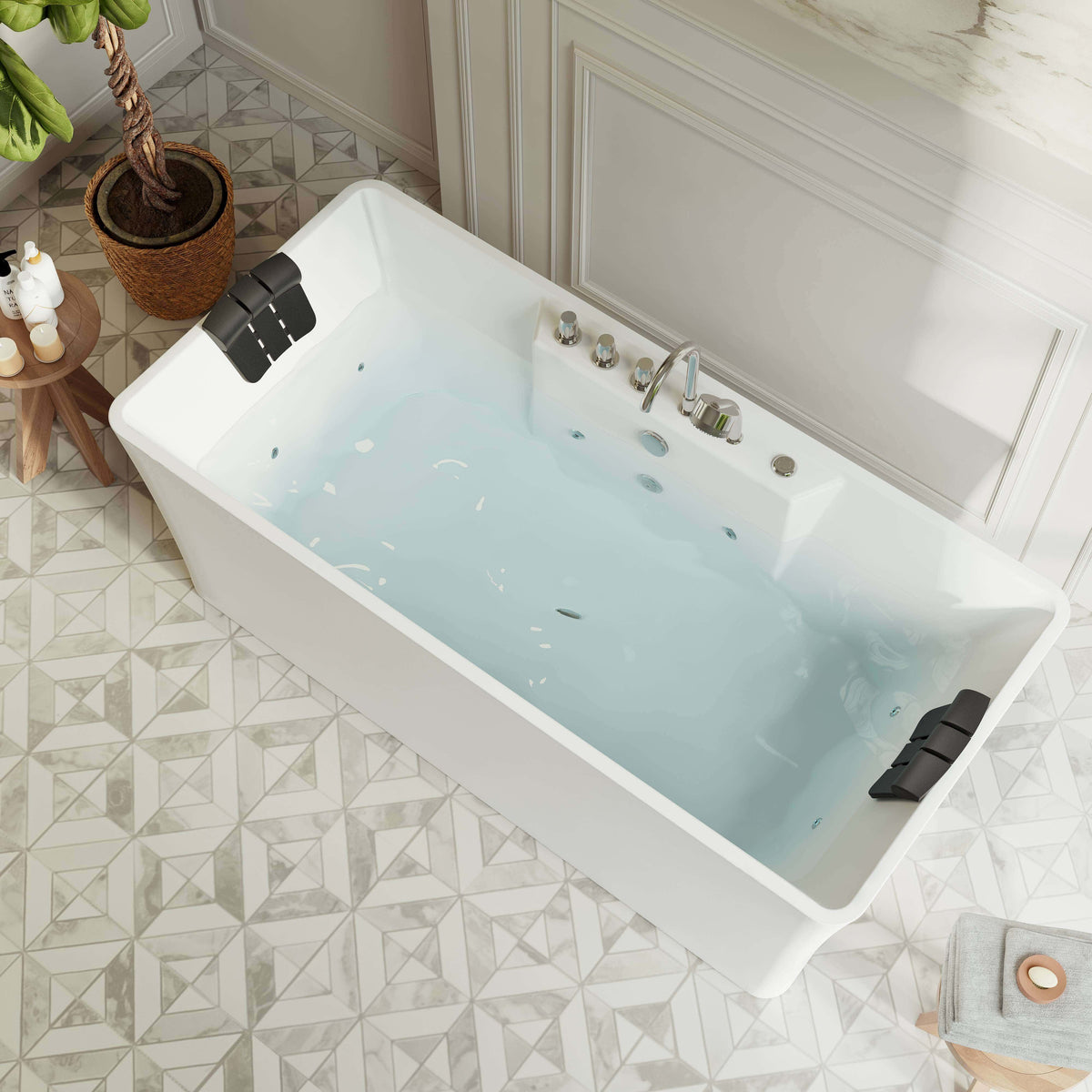 Freestanding white acrylic whirlpool tub with chrome faucet and water jets, angled view