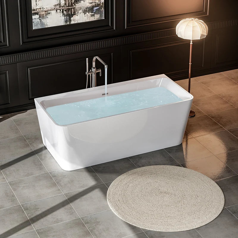 Freestanding soaking tub, glossy white exterior with water-filled interior and chrome faucet.