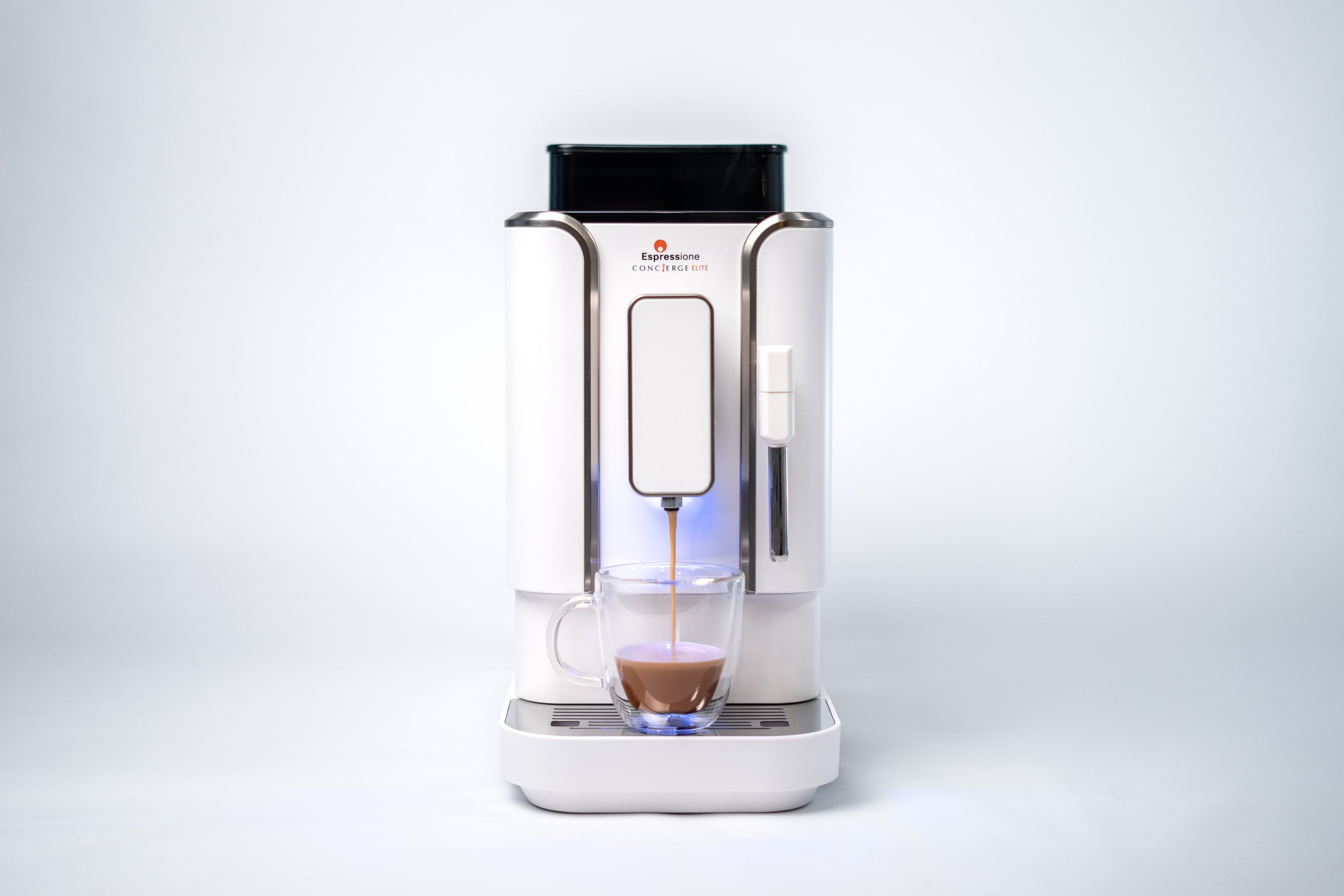 Diamond white espresso machine with built-in spout and filled glass cup, blue indicator light