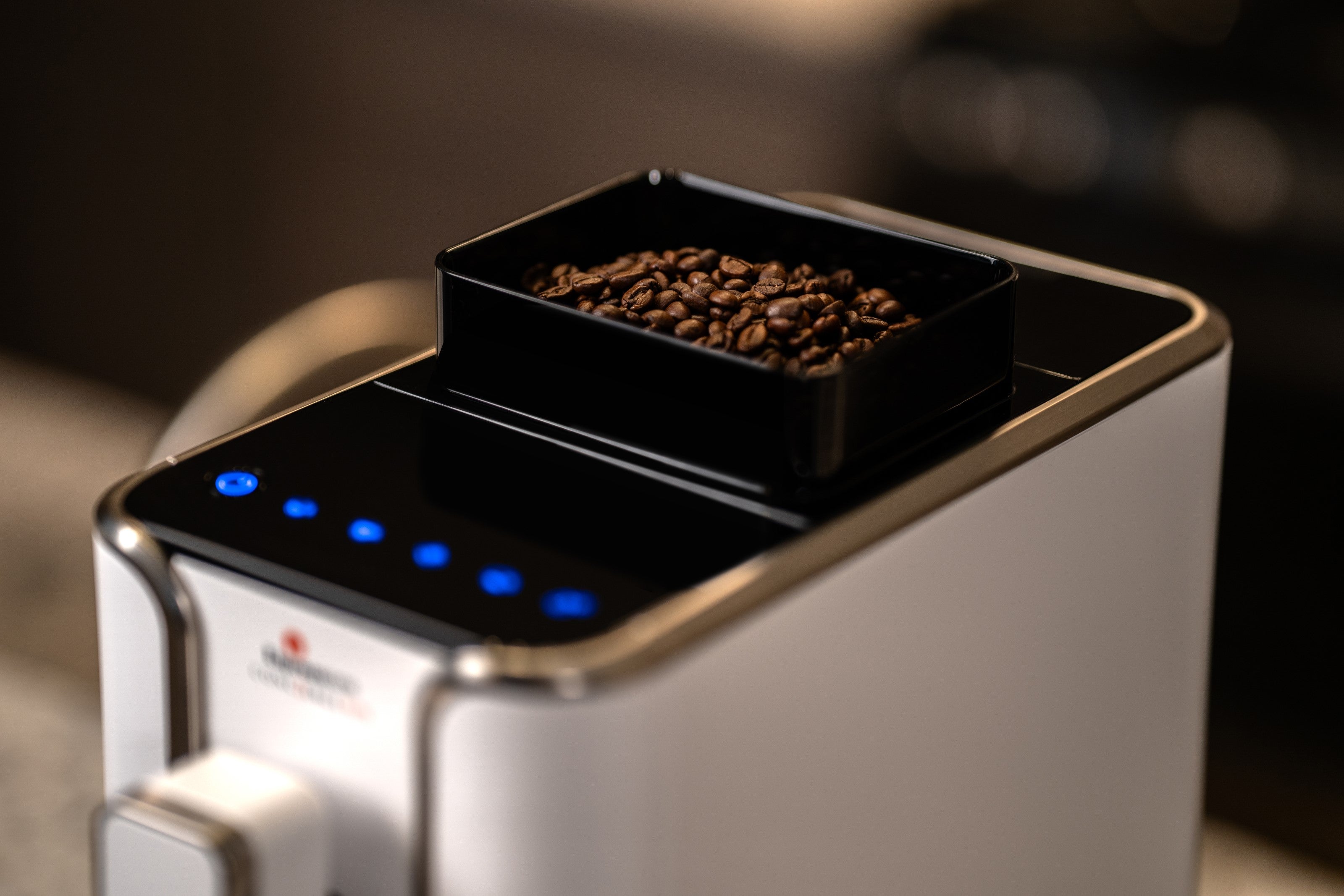 Diamond white bean-to-cup espresso machine with grinder chute loaded with coffee beans
