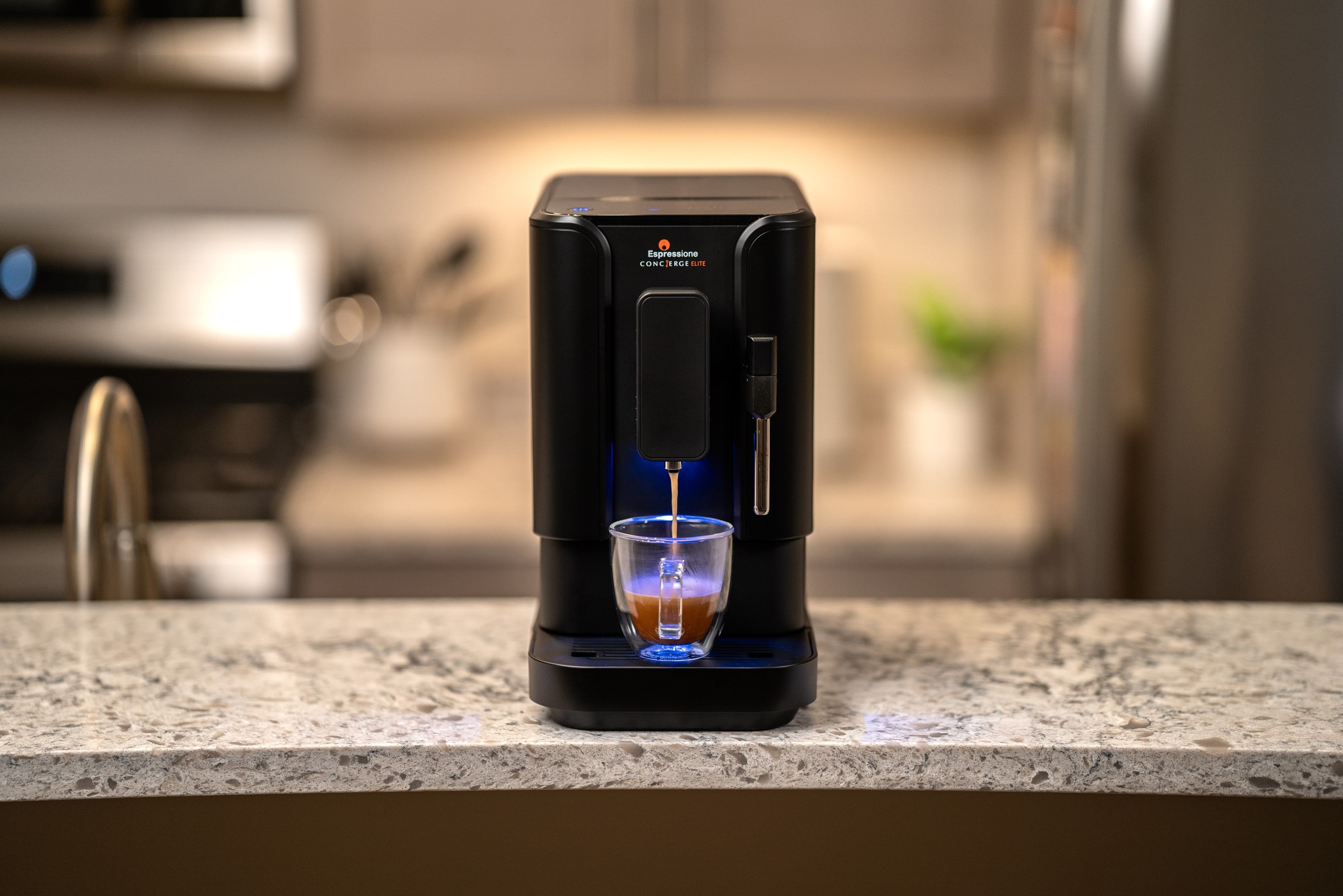 Black fully automatic bean-to-cup espresso machine dispensing a cup
