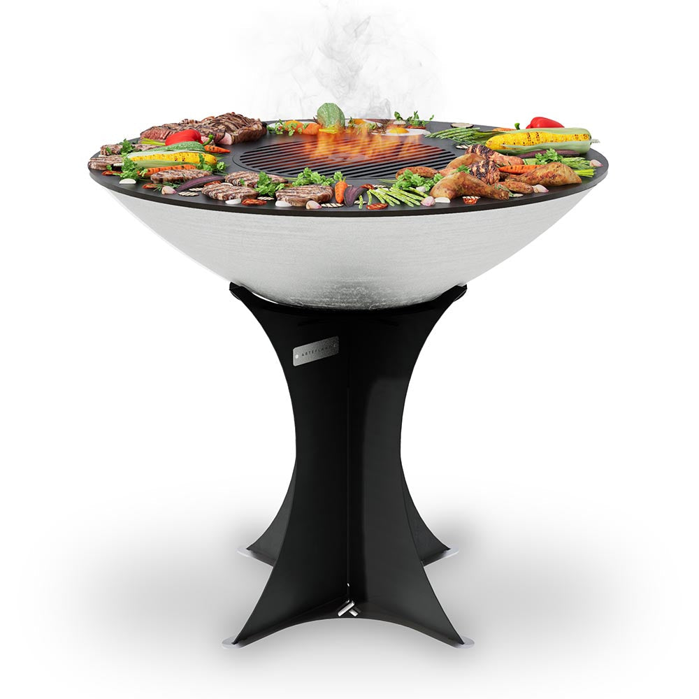 Black flat-top charcoal grill with open flame and pedestal base, front view